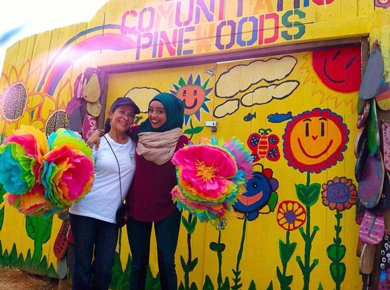 Ms. Aída Quiñones (left), Branch Manager of the Pinewoods Library and Community Education Center, with friend at entrance to the Pinewoods Garden.